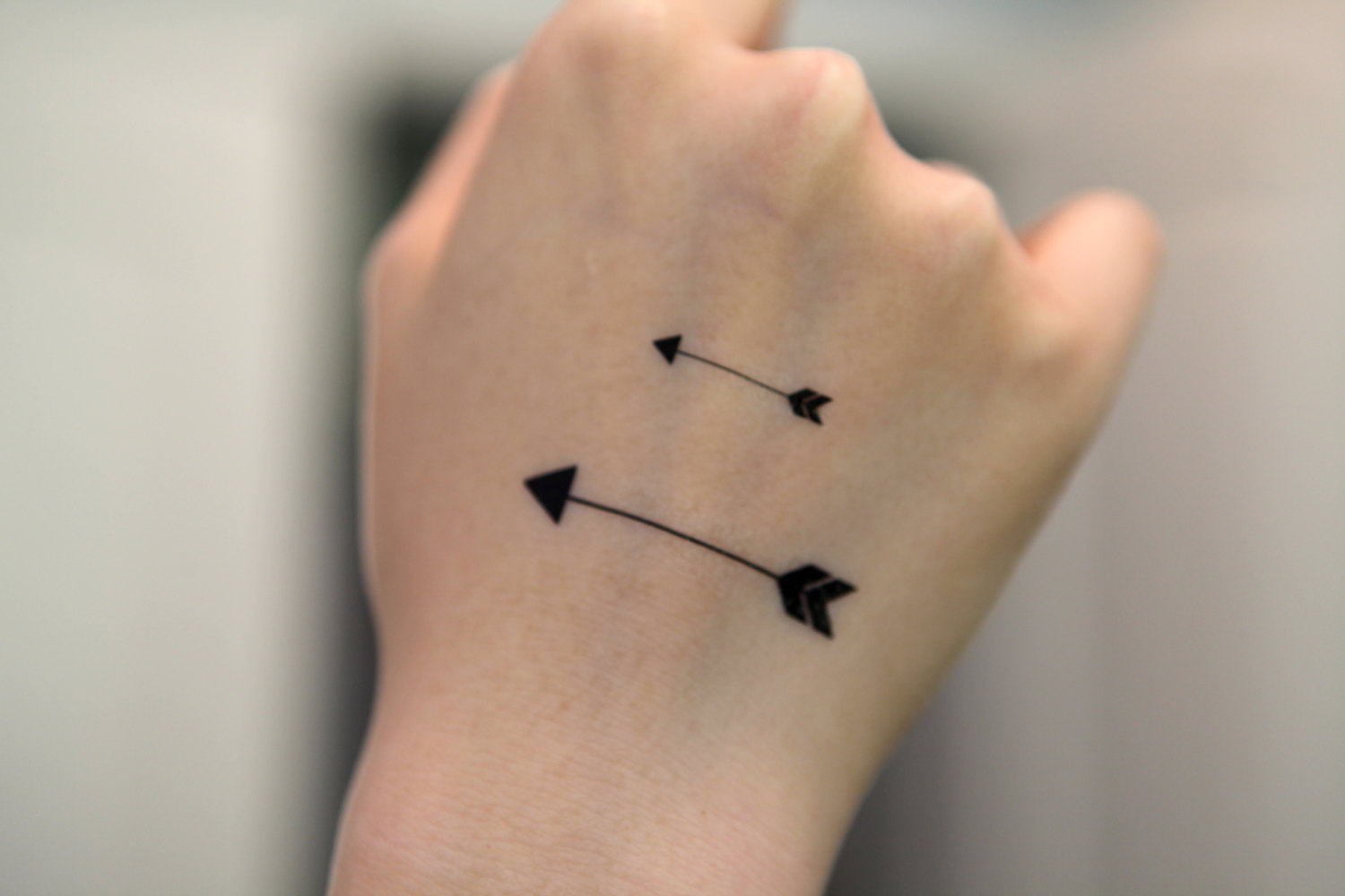 10. Arrow Tattoo Designs with Symbols for Women - wide 6