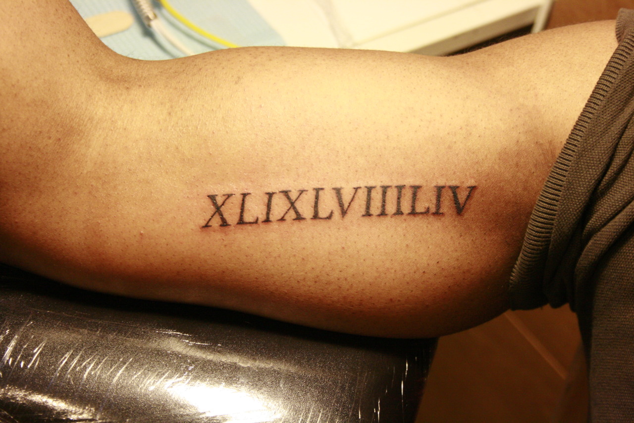 3. Small Roman Numeral Bicep Tattoos - wide 1