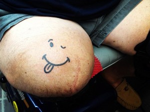 Smiley Face Tattoo on Knee